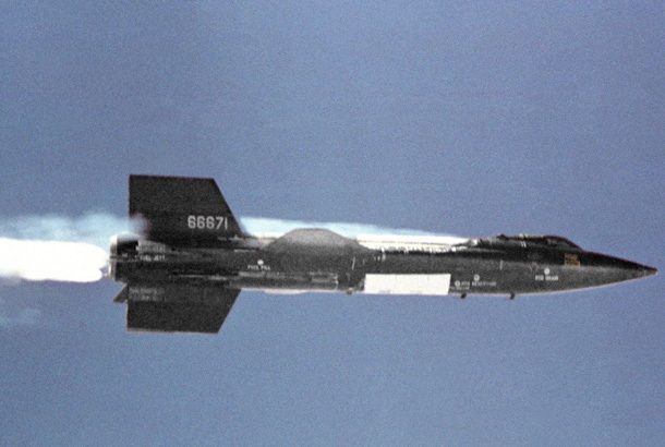 X-15 airplane flying with white contrails behind it