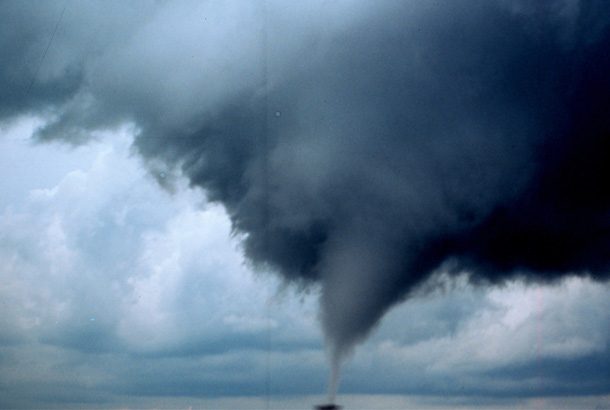Large tornado approaching a house