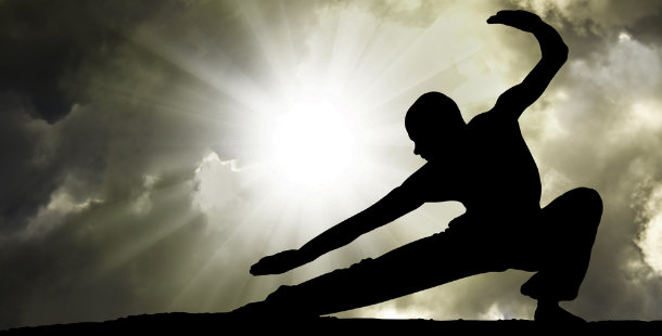 Silhouette of a man in martial art form position