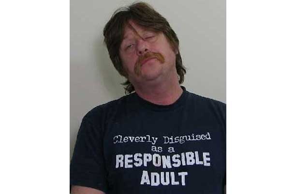 Man with shirt that says Cleverly disguised as a responsible adult