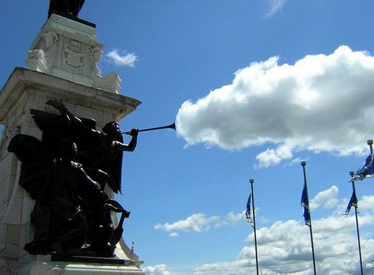 Statue's trumpet blowing clouds