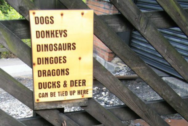 sign that says Dogs, Donkey's Dinosaurs, Dragons, Ducks, and Deer can be tied here