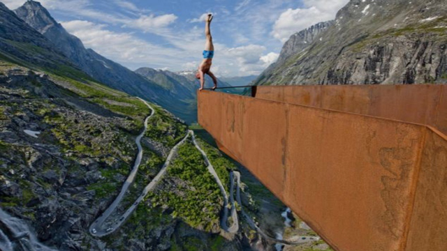 Eskil Ronningsbakken doing a handstand on the edge of a metal beam