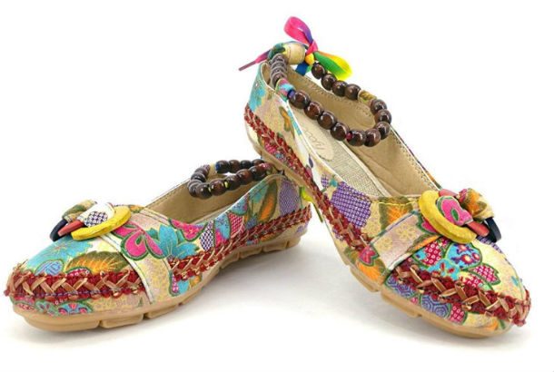 brown slippers with colorful images, laces, and beaded ankle bracelet