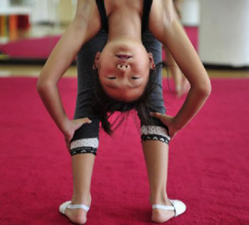 Young gymnast doing a backbend