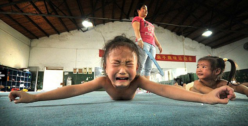 Young Chinese gymnast crying in pain
