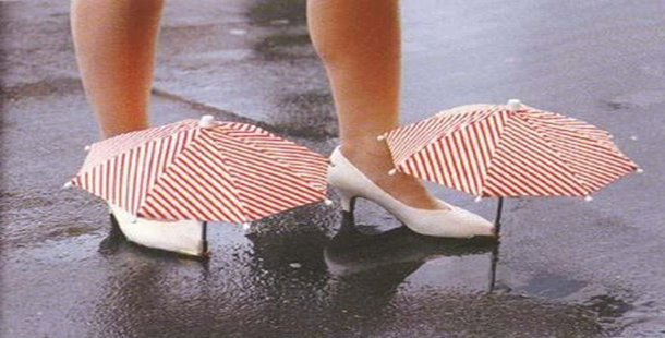 A person's legs with umbrellas