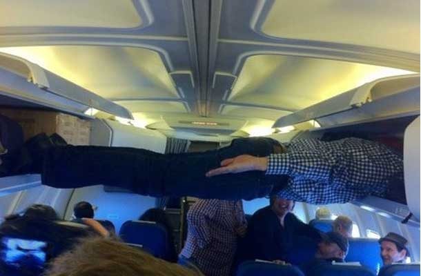 planking across airplane overhead bins