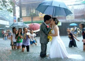 Filipino couple exchange vows during a fierce monsoon rain