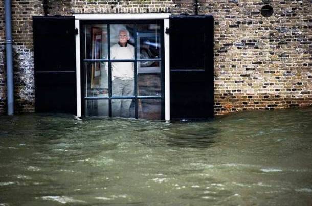 Man watches the flood through his window in Netherlands