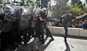 A greek protester kicks the riot police