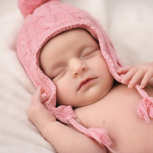 Newborn baby in pink hat