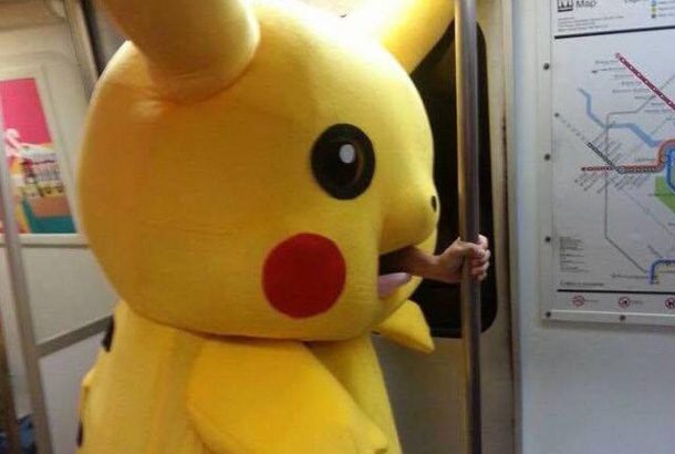 man with hand sticking out of mouth of pickachu costume