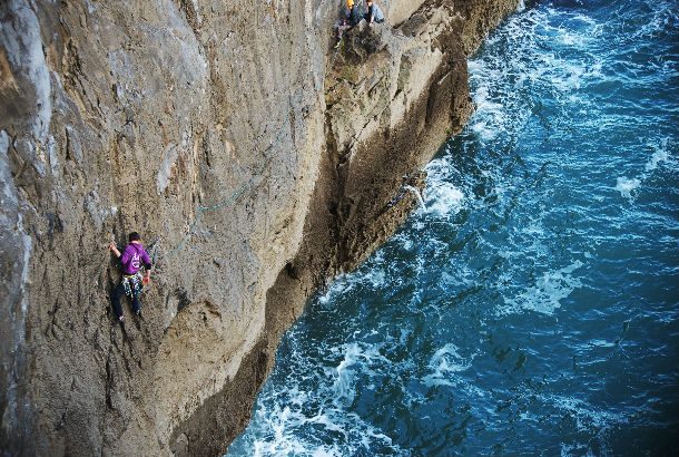 two climbers climbing from the ocean