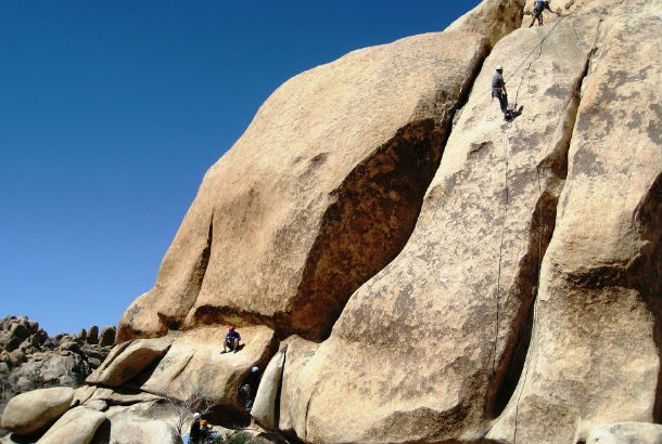 climbers climbing up smooth rounded mountainface