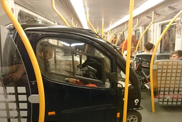 small black car with person inside in subway