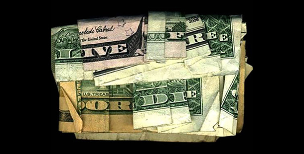 Folded dollar bill that says, "Live free or die"