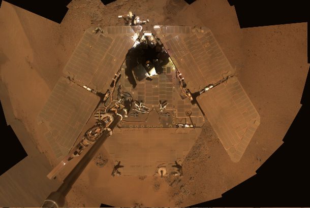 image of solar panels covered in red dust