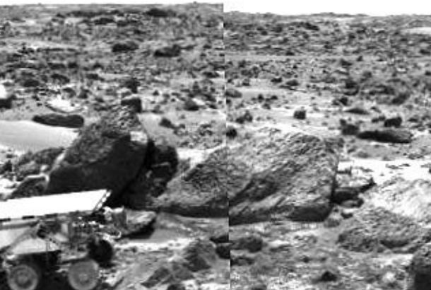 black and white image of rover in rocks