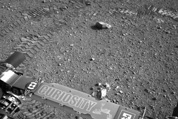 close up of back of rover with tire tracks in background