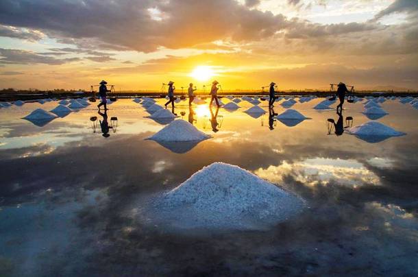 People Harvesting Salt at Sunset