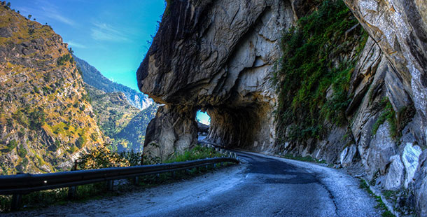 A road going through a mountainous tunnel