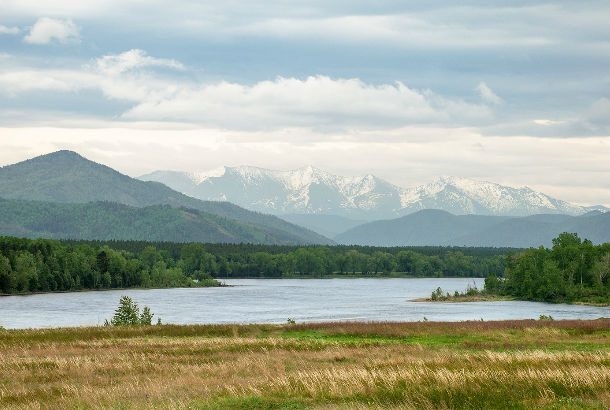 Yenisei River from bank with mountain in background