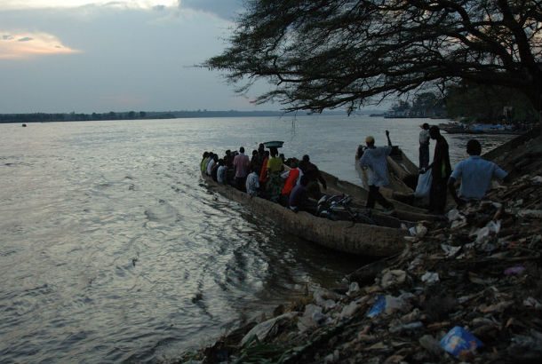 Congo River from bank with boat full of people