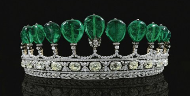 A crown with green gems on it