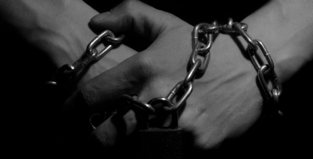 A hand with a chain around it