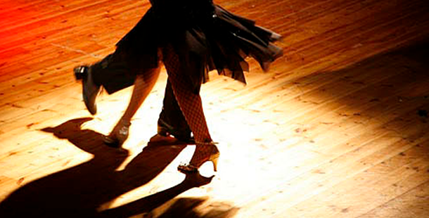 A person dancing on a wooden floor