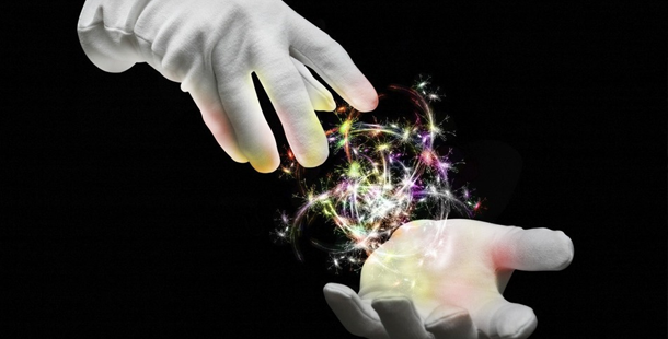 A pair of hands touching a glowing object