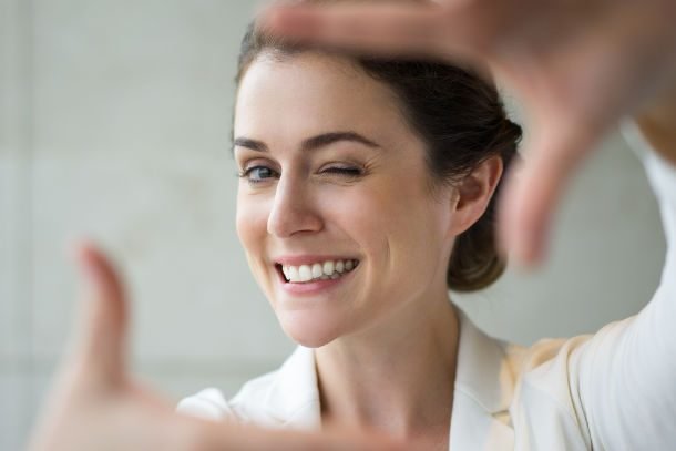 smiling woman hands in frame