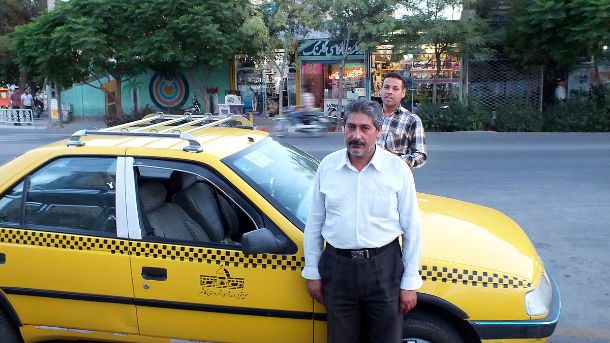taxi driver standing outside his cab