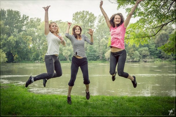 3 girls jumping and smiling
