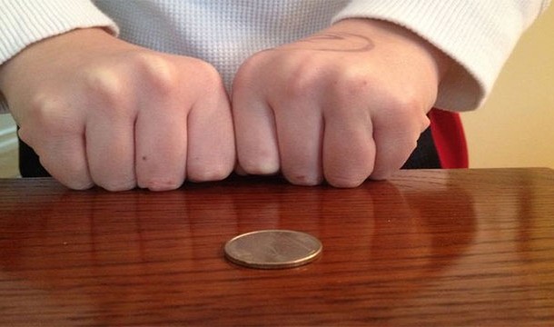 Bloody knuckles with a coin
