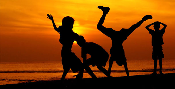 A group of people dancing on the beach