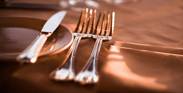 A close-up of a fork and knife on a table