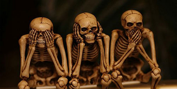 A group of skeletons sitting on a table