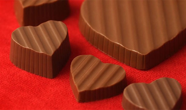 Chocolate hearts against red background