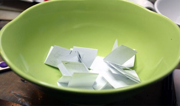 Image of folded notes inside a green bowl
