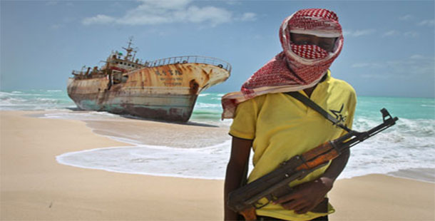 Somali pirates on a beach with a gun
