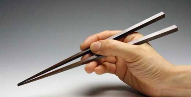 A person holding a pair of tongs