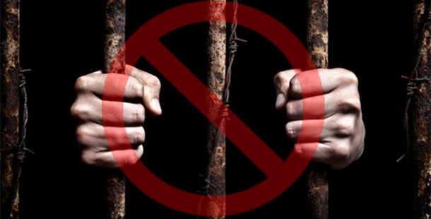 Hands holding bars with a red circle
