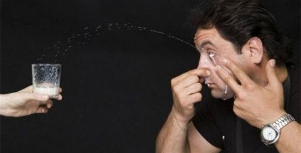 A person squeezing his nose with water drops, ridiculous world records