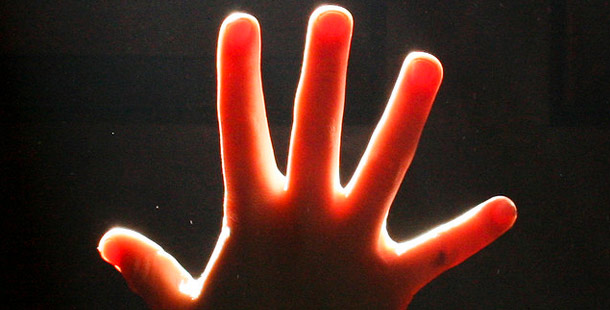 A hand with a bright light shining on it