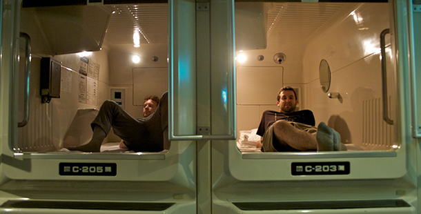 Two men in a capsule hotel
