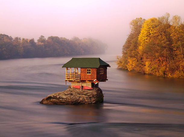 a house on a rock in water