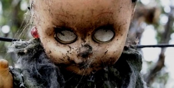 A close up of a creepy doll, uncover toy horror