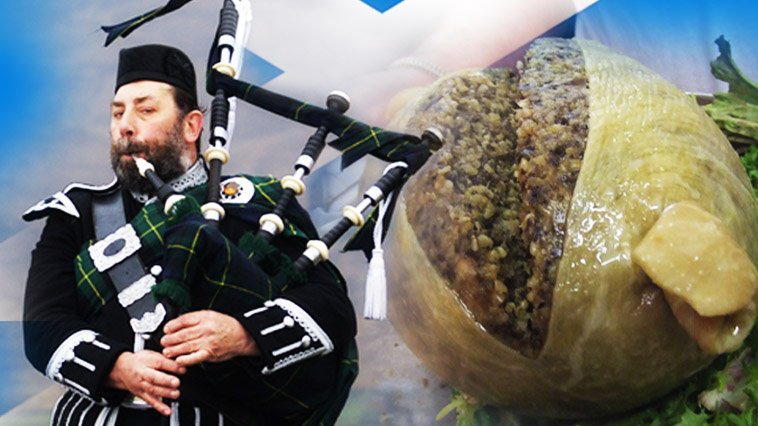 A person playing bagpipes in front of a large bag
